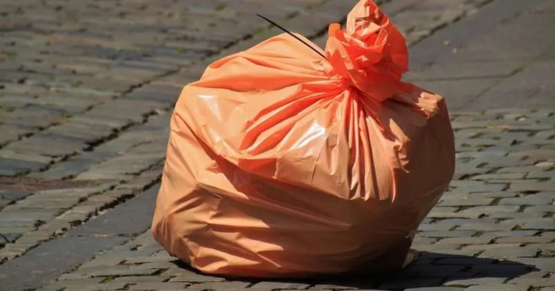 石畳の上に置かれた結び口のごみ袋