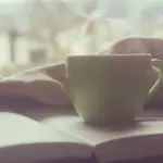 湯気の立つマグと本 静かな朝のテーブル