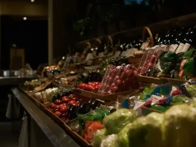 夜のスーパー青果売り場に並ぶ野菜と果物