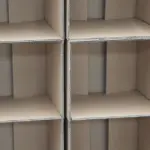 段ボール箱で区切られた空の棚